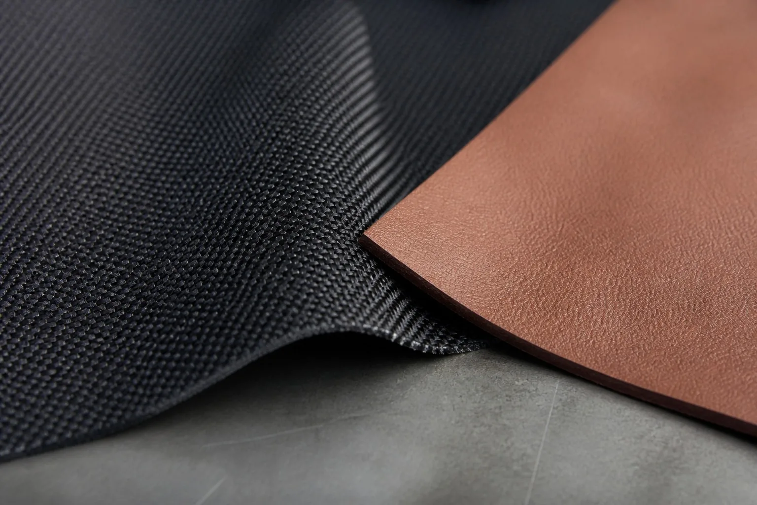 Nylon fabric texture next to smooth leather sample