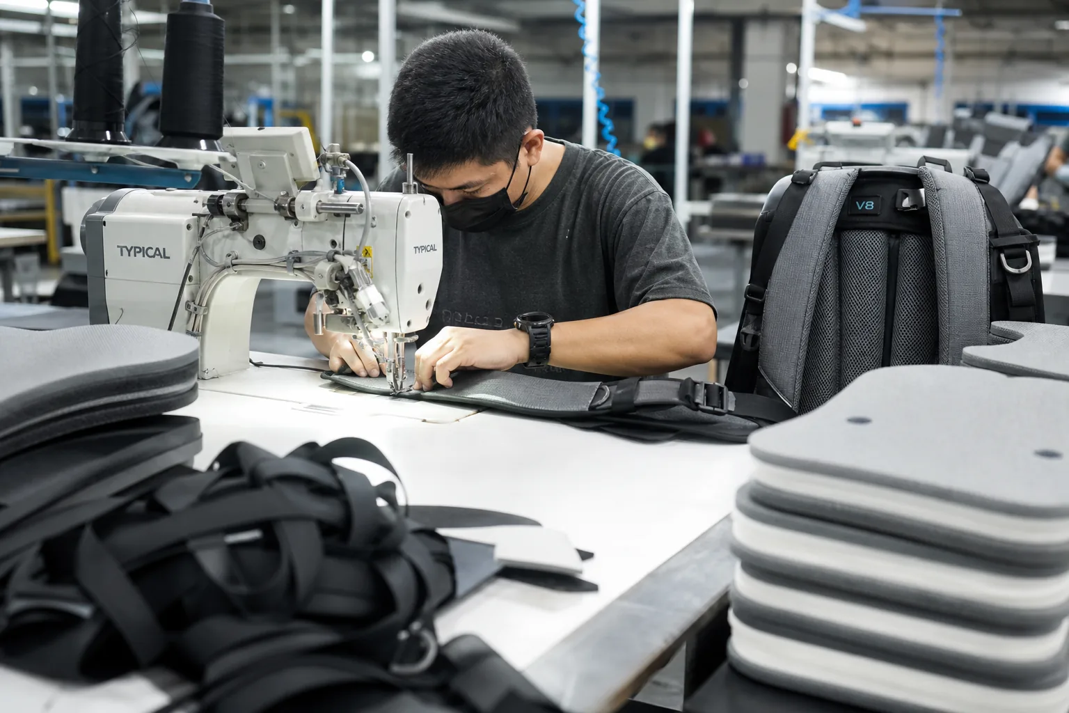 Harness assembly station sewing a padded shoulder strap