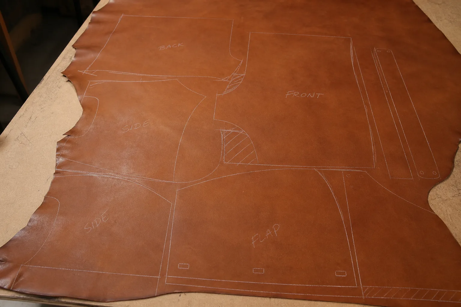 Leather pattern pieces nested on hide