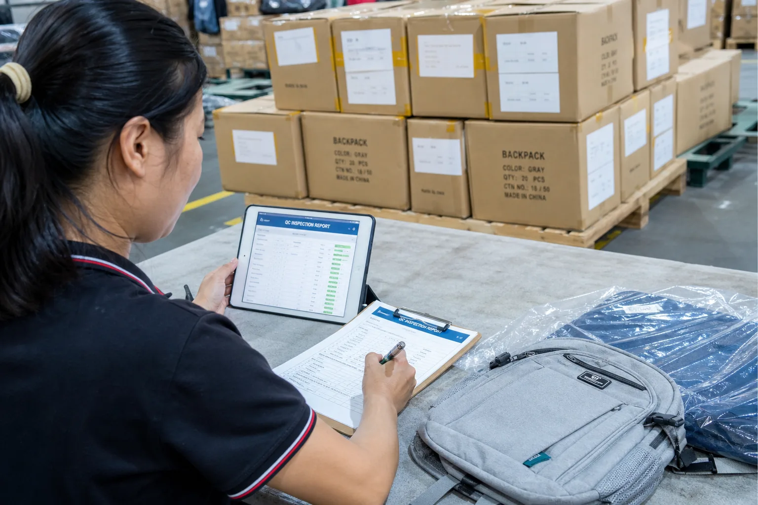 QC inspection report being completed at the packing station