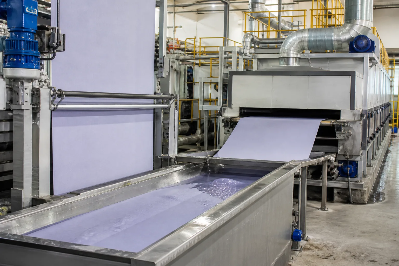 Fabric passing through a padding trough and drying oven during a treatment application
