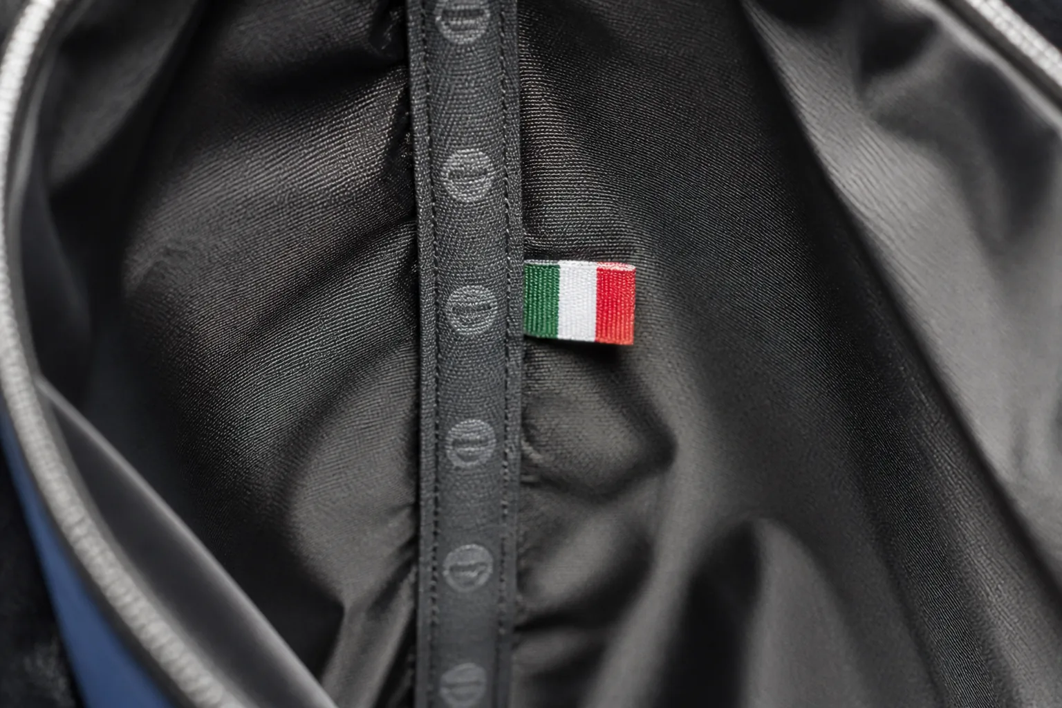 A bag interior seam with a printed origin marking tape and a small woven flag label